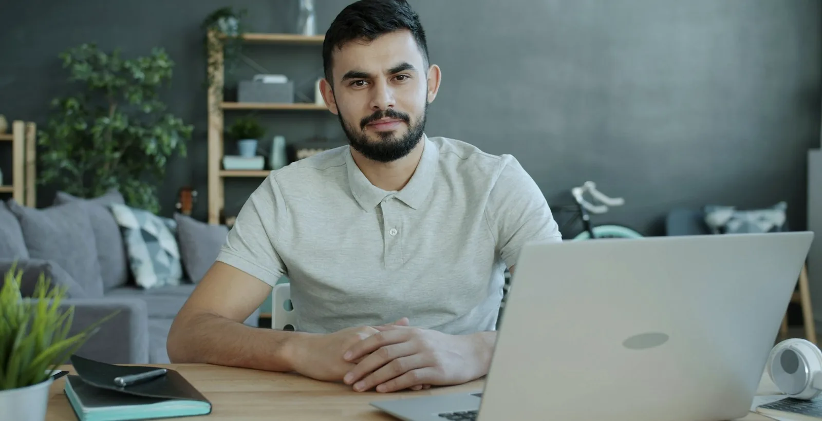 A person working alone at a laptop in a home workspace