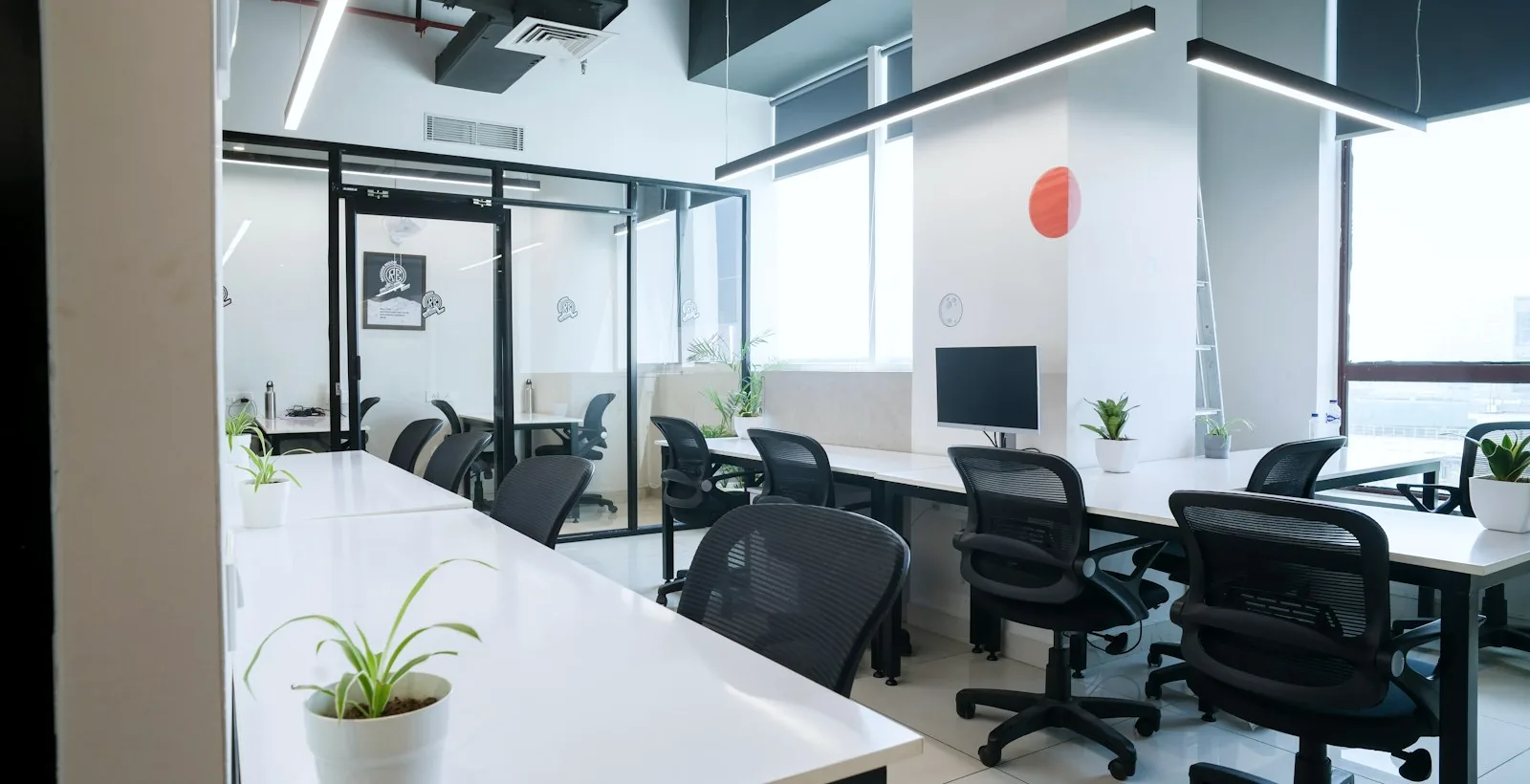 An empty open-plan office with desks and chairs waiting to be filled